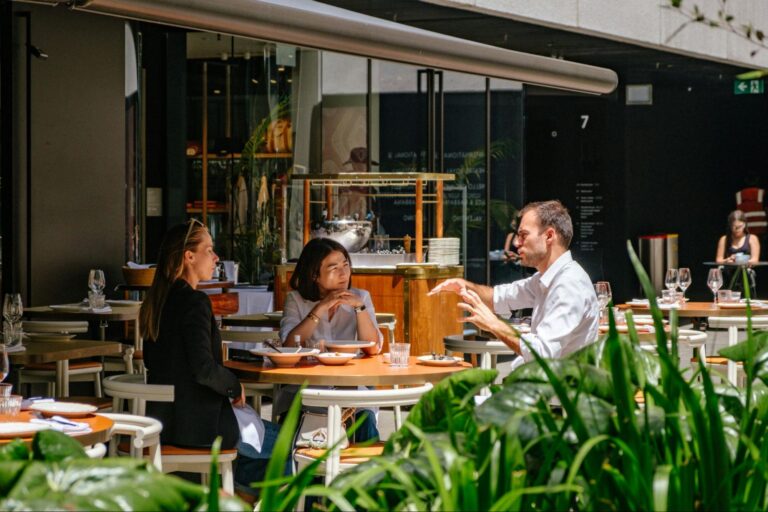 Three people sitting at a cafe